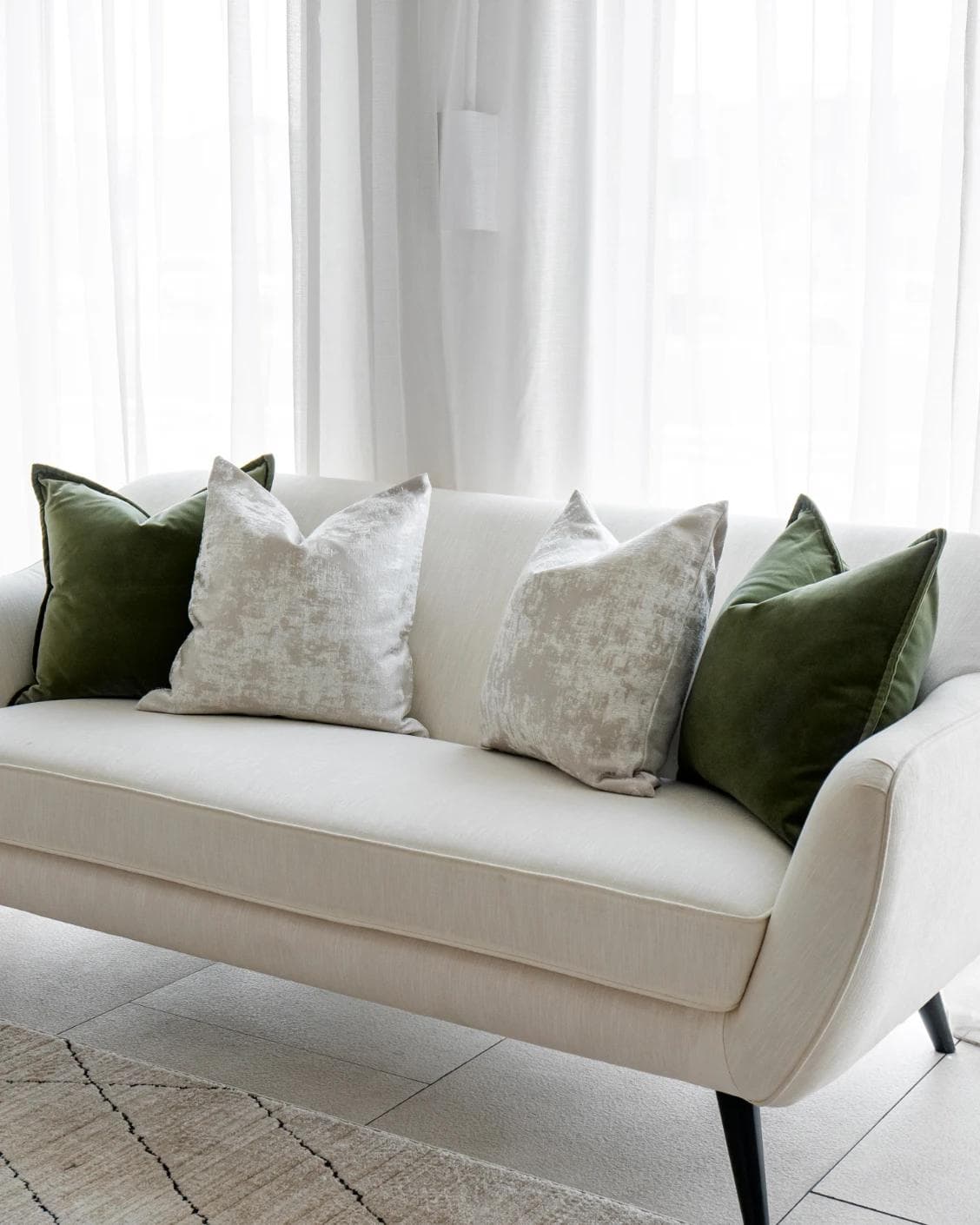 Jayce Bundle cushion in forest green, silver, grey and green, shown in a lifestyle right view as image 2
