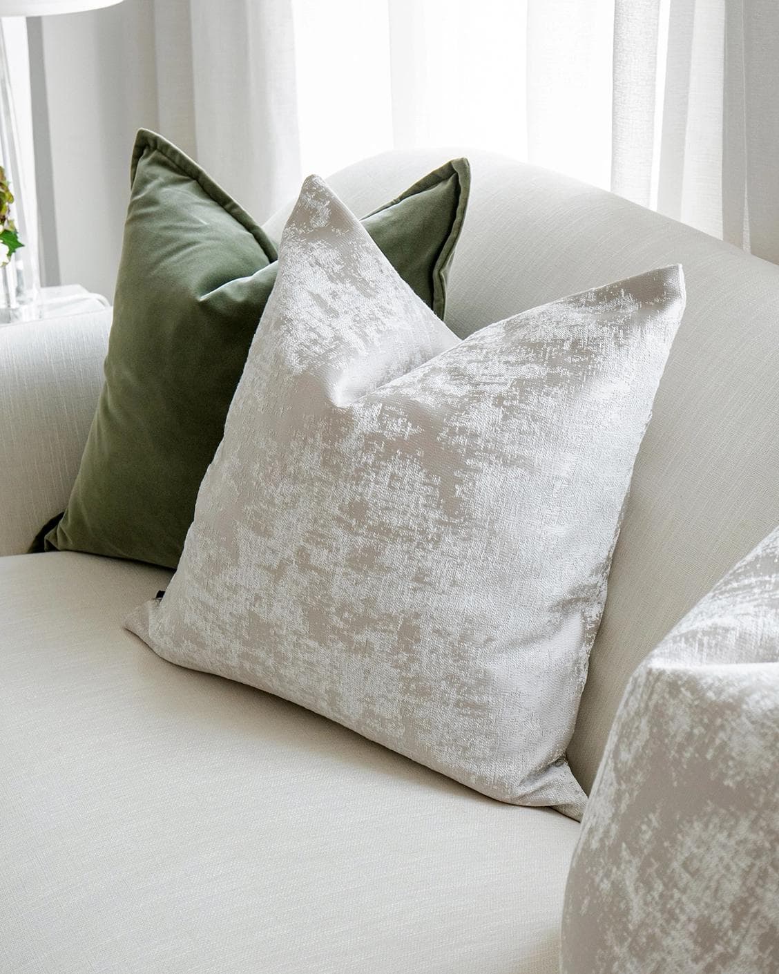 Jayce Bundle cushion in forest green, silver, grey and green, shown in a lifestyle right view as image 5