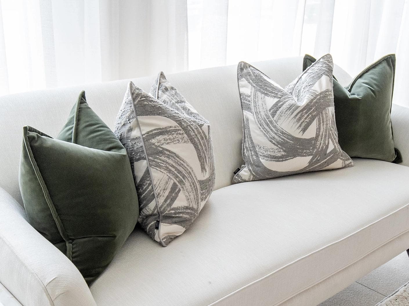 Cattleya Bundle cushion in green, white and grey, shown in a lifestyle left view as image 4