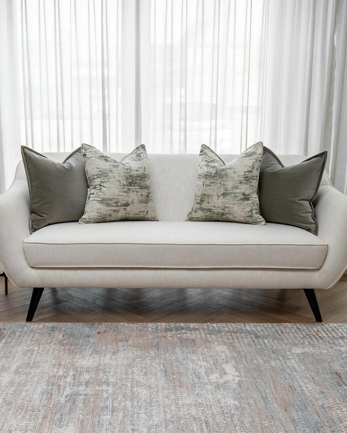 Mylene Bundle cushion in grey and white, shown in a lifestyle front view as image 4