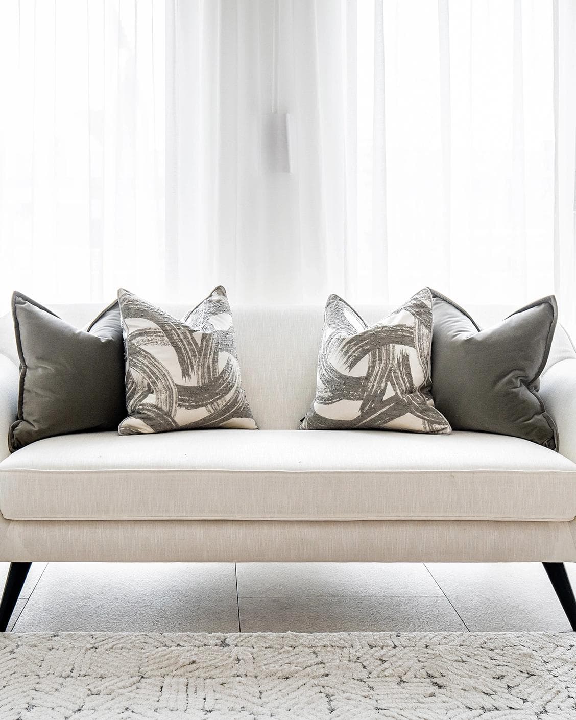 Lilian Bundle cushion in grey and white, shown in a lifestyle front view as image 4