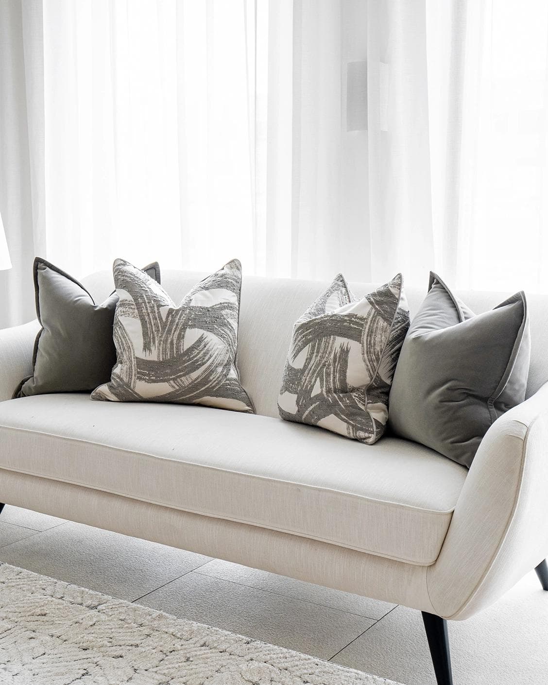 Lilian Bundle cushion in grey and white, shown in a lifestyle right view as image 2