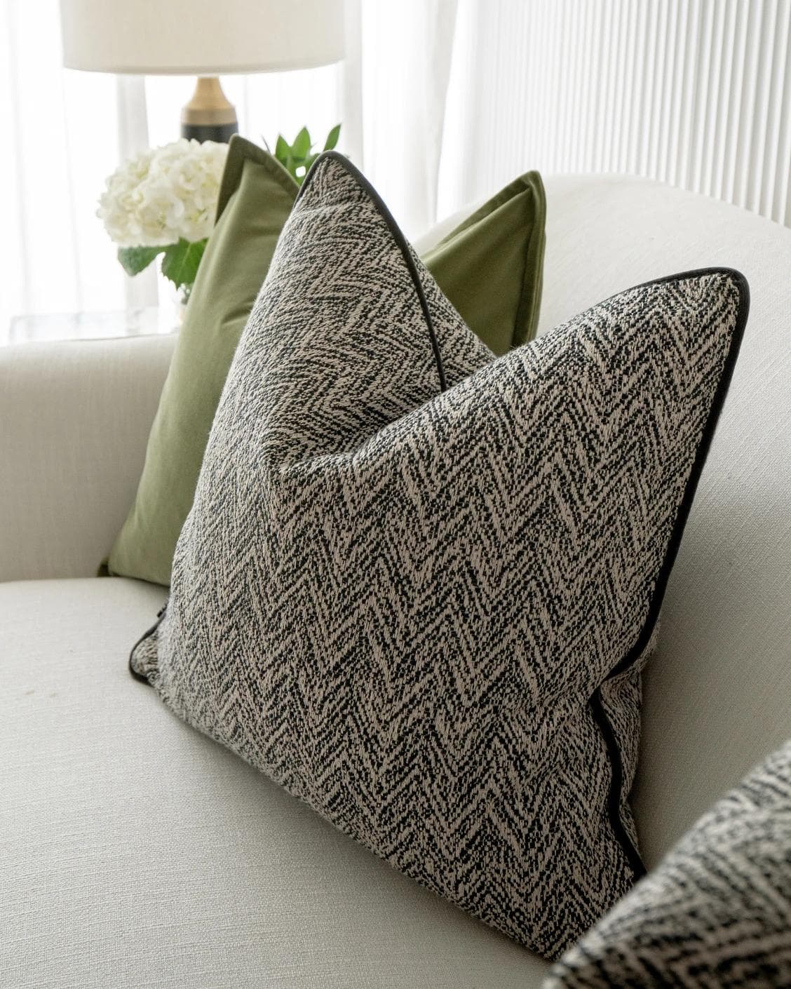 Maribel Bundle cushion in black, white and green, shown in a lifestyle right view as image 6