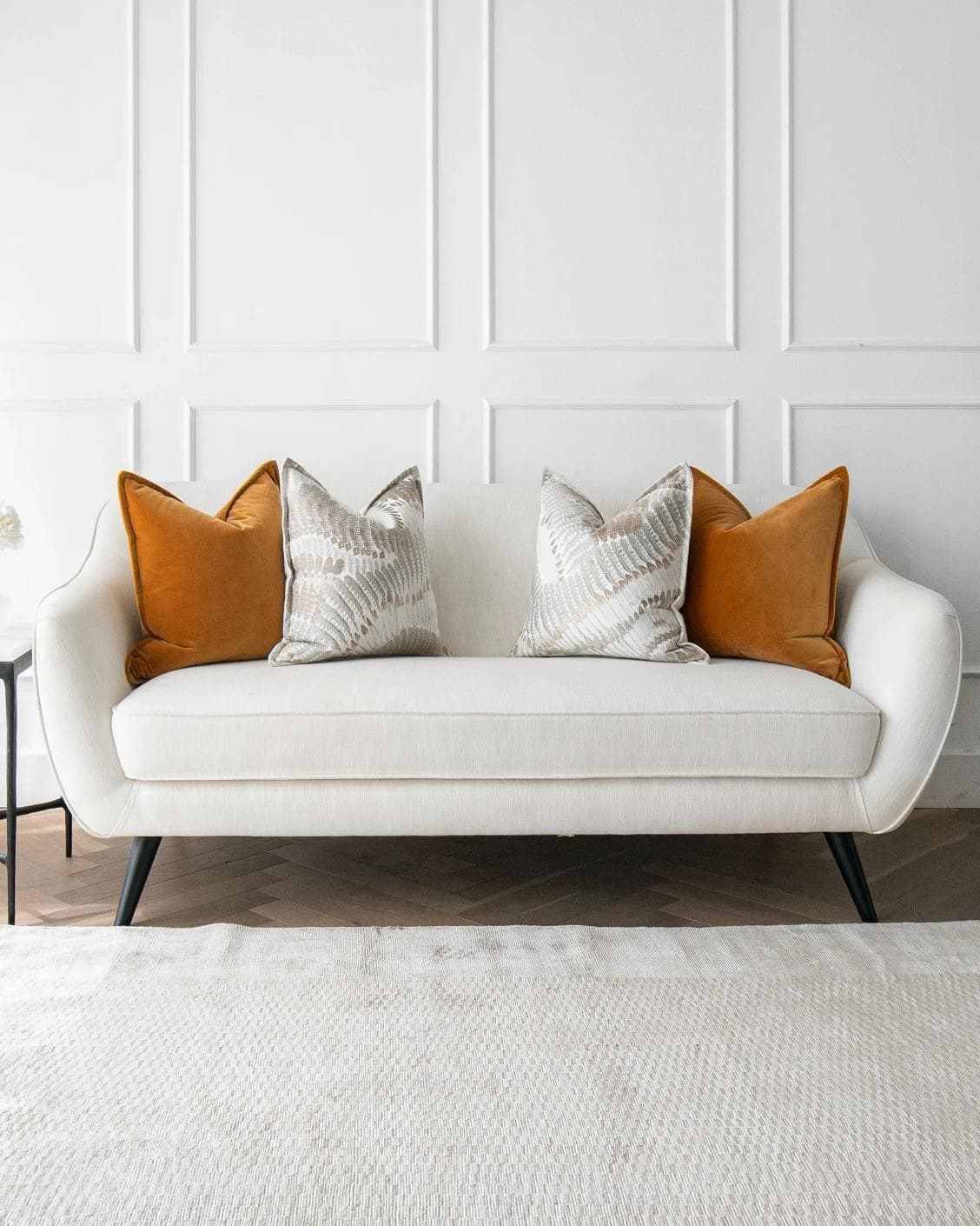 Emilia Bundle cushion in orange, brown and grey, shown in a lifestyle front view as image 4
