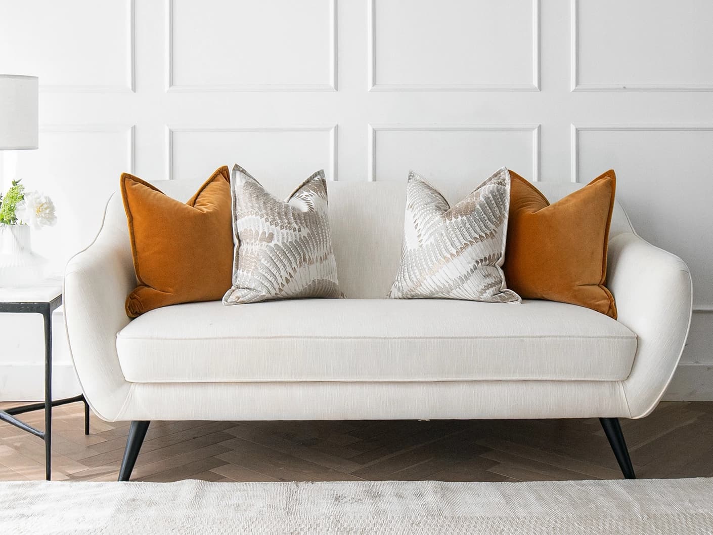 Emilia Bundle cushion in orange, brown and grey, shown in a lifestyle front view as image 4