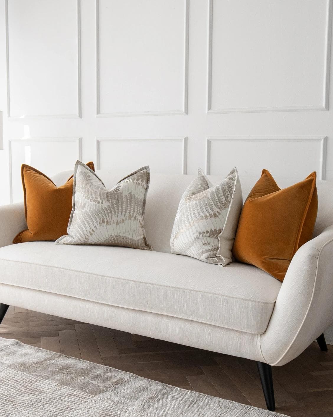Emilia Bundle cushion in orange, brown and grey, shown in a lifestyle right view as image 2