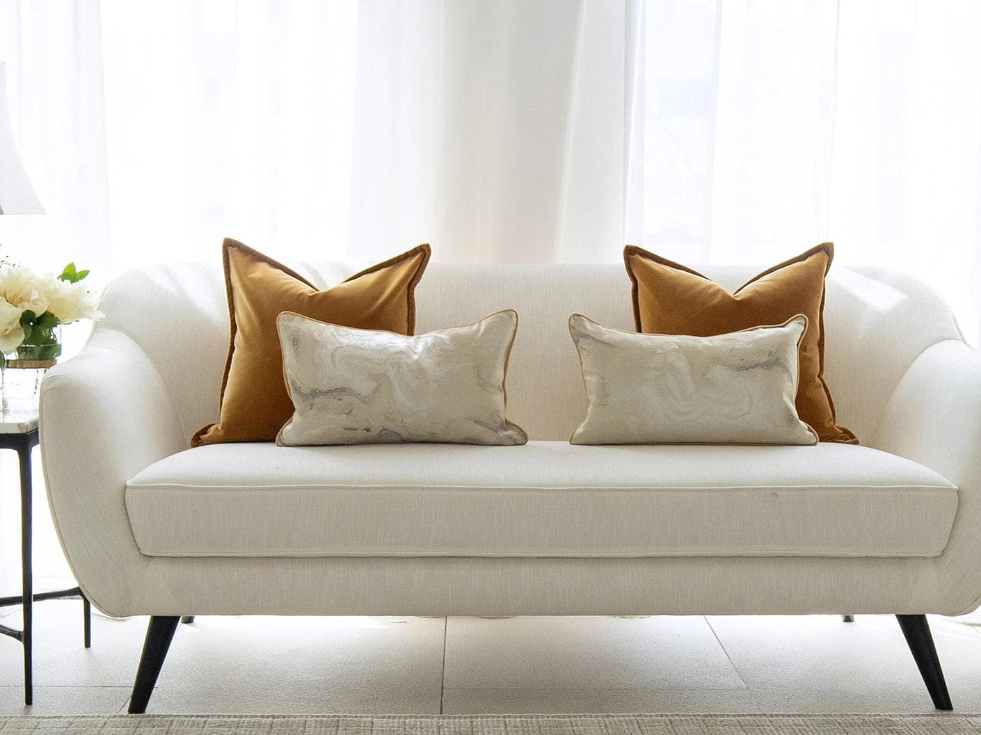 Johan Bundle cushion in orange, silver and yellow, shown in a lifestyle front view as image 4