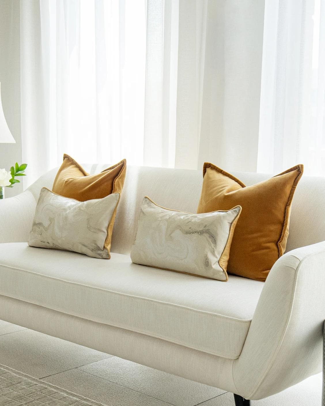 Johan Bundle cushion in orange, silver and yellow, shown in a lifestyle right view as image 2