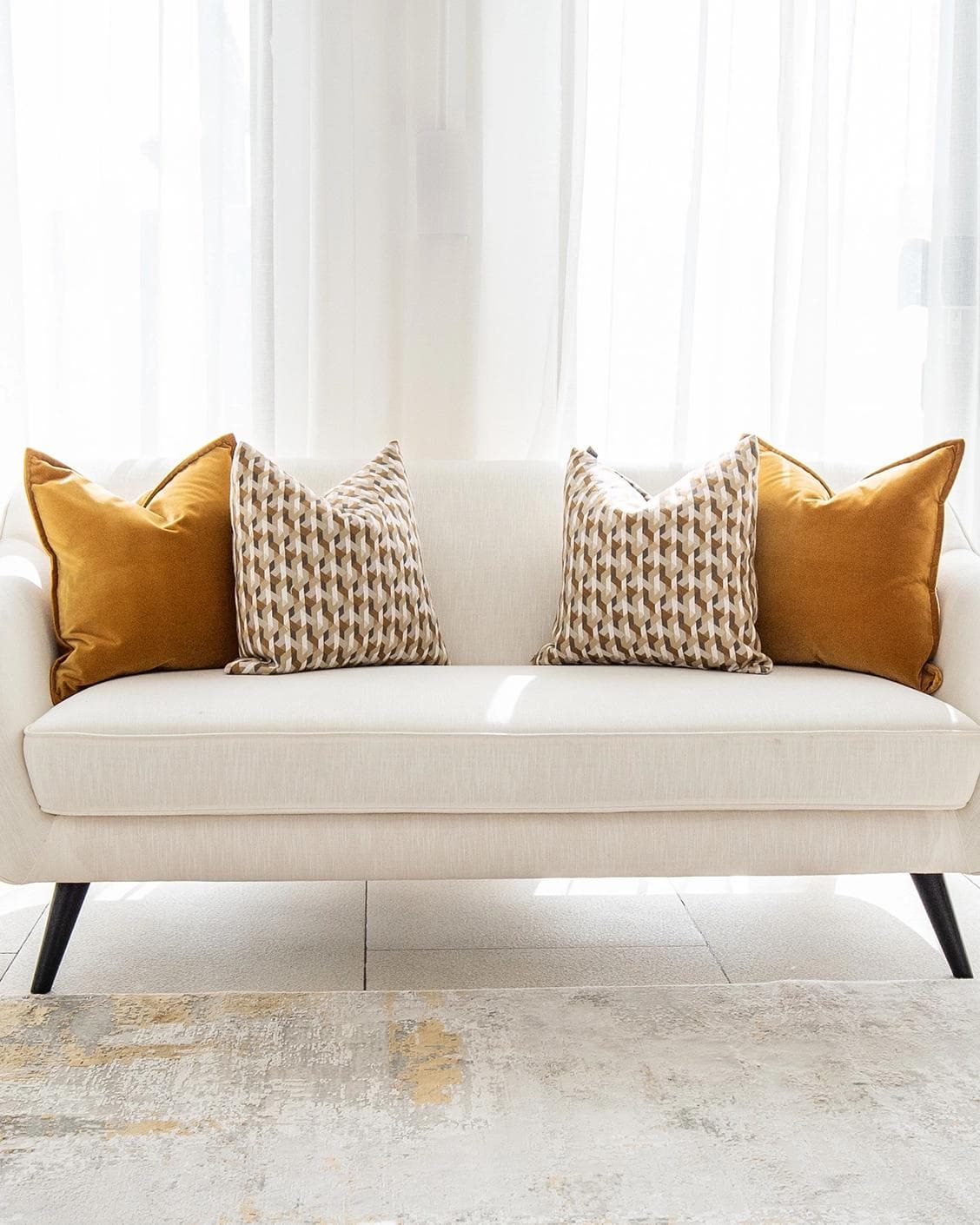 Phoebe Bundle cushion in orange, shown in a lifestyle front view as image 4