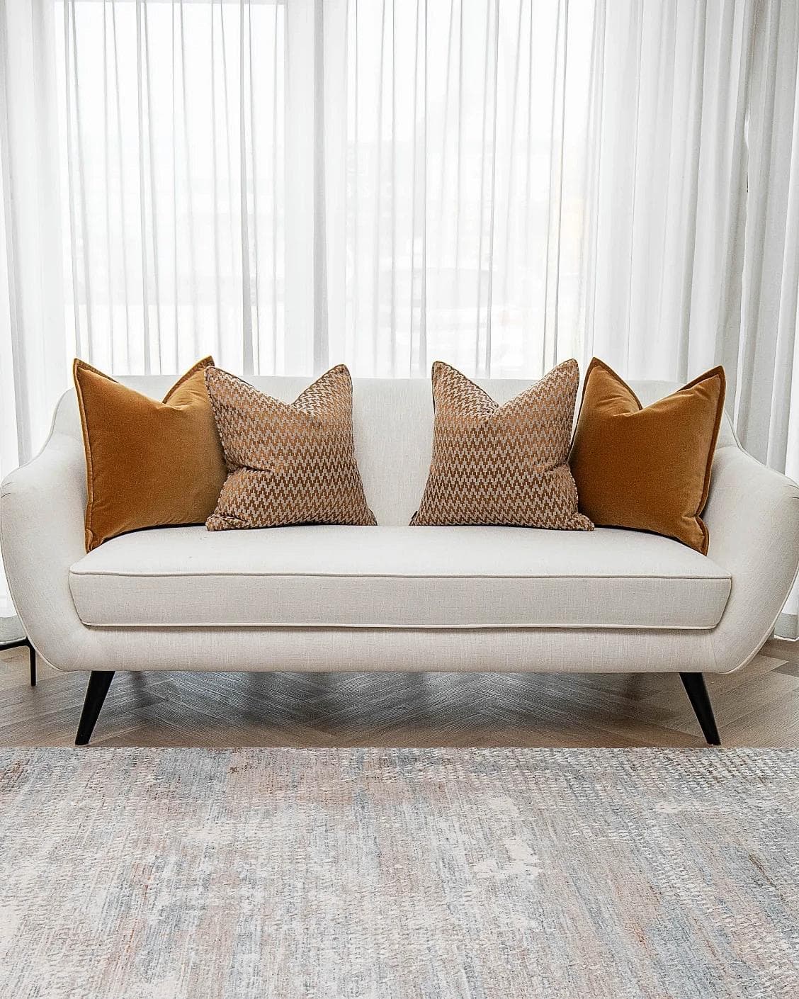 Cleopatra Bundle cushion in orange, shown in a lifestyle front view as image 4