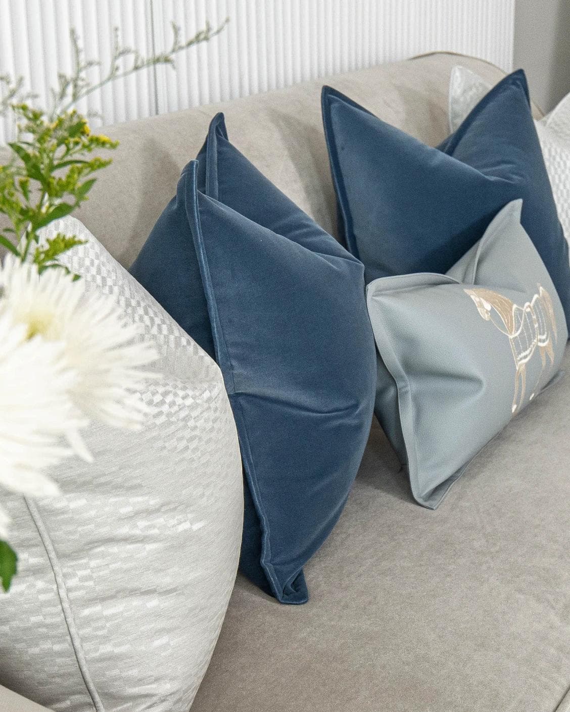 Kristal Bundle cushion in blue, silver and white, shown in a lifestyle left view as image 5