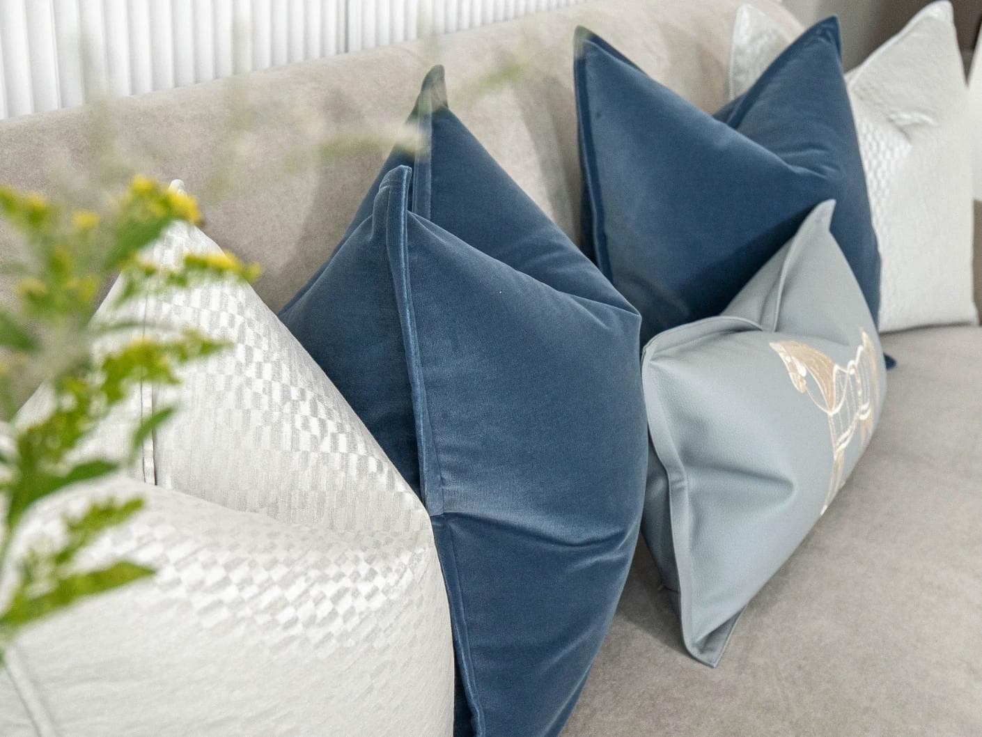 Kristal Bundle cushion in blue, silver and white, shown in a lifestyle left view as image 6