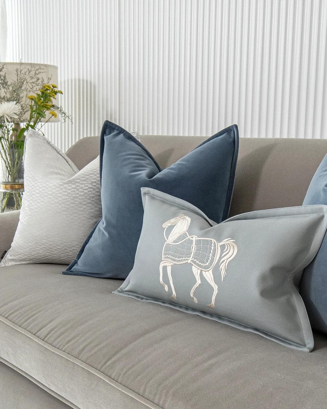 Kristal Bundle cushion in blue, silver and white, shown in a lifestyle right view as image 7