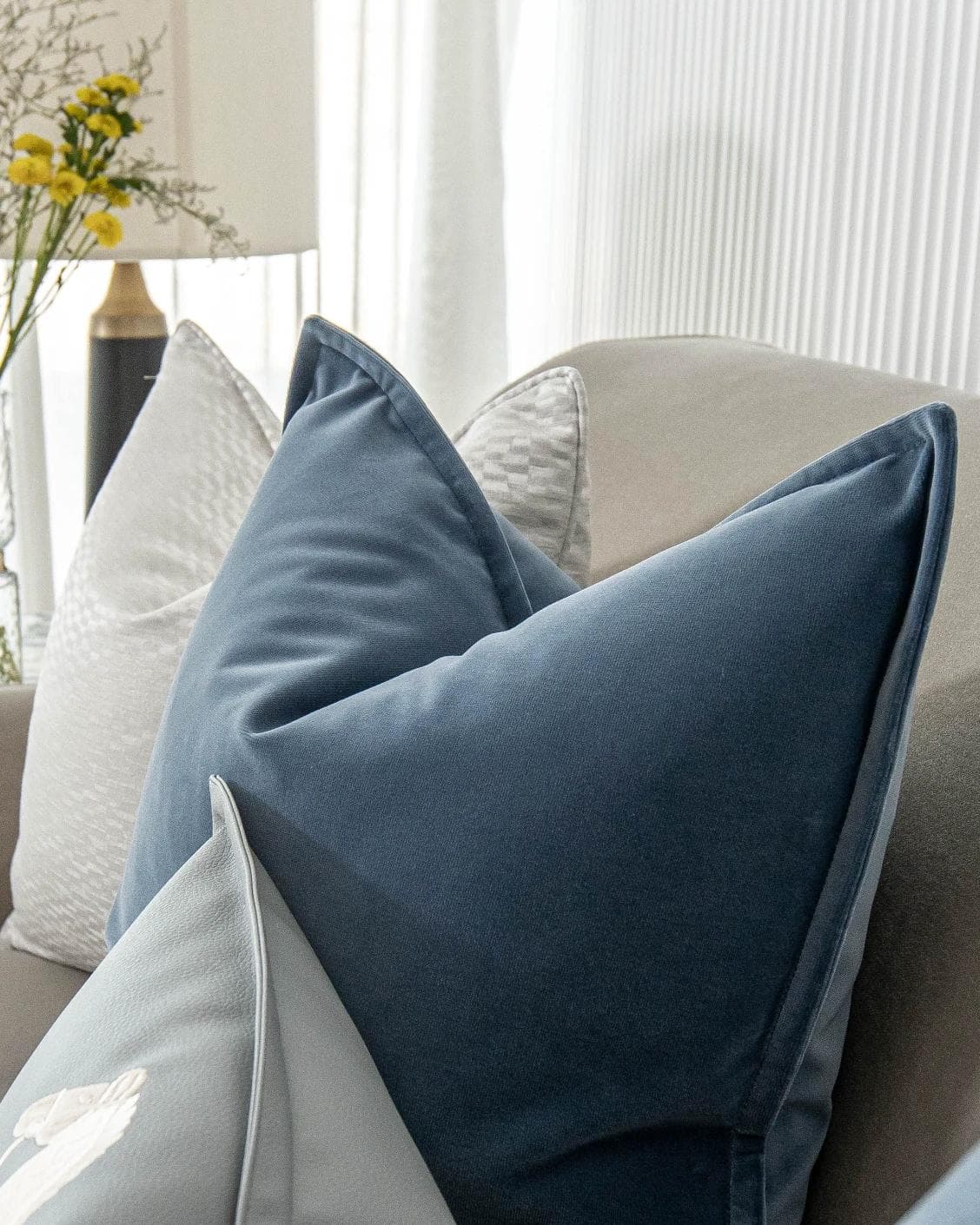 Kristal Bundle cushion in blue, silver and white, shown in a lifestyle right view as image 8