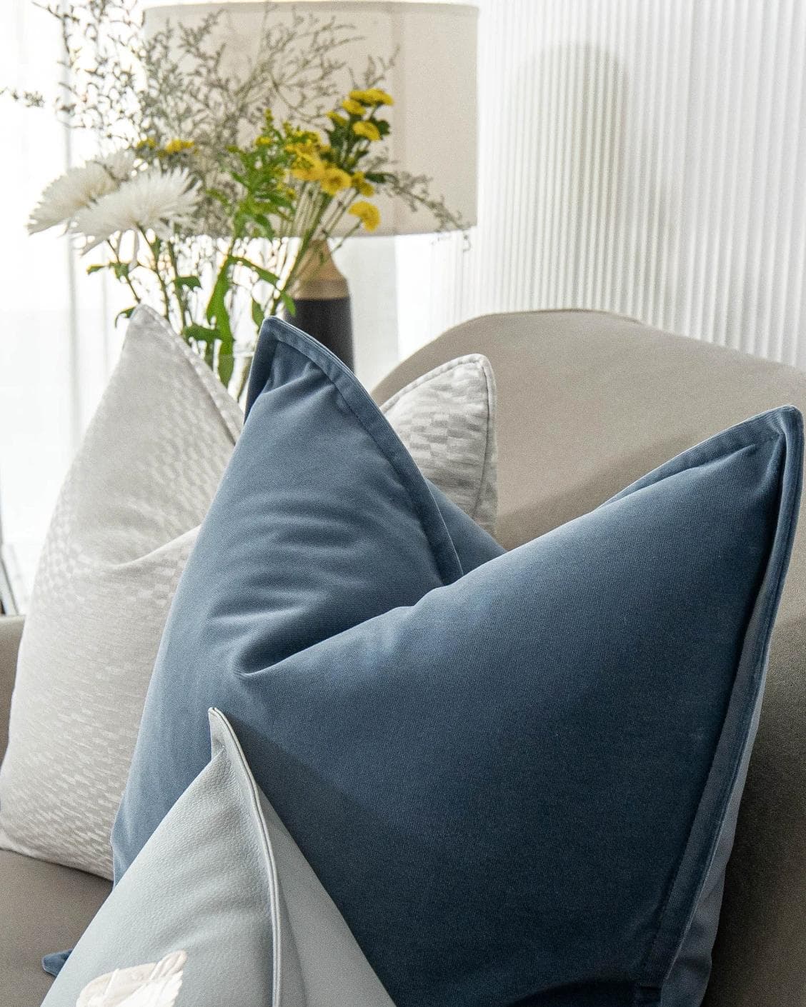 Kristal Bundle cushion in blue, silver and white, shown in a lifestyle top view as image 10