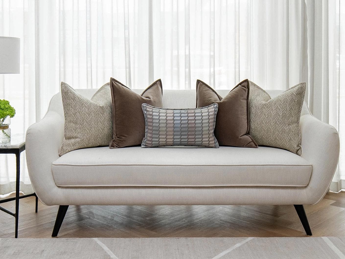 Jovie Bundle cushion in silver, blue, brown and beige, shown in a lifestyle front view as image 4