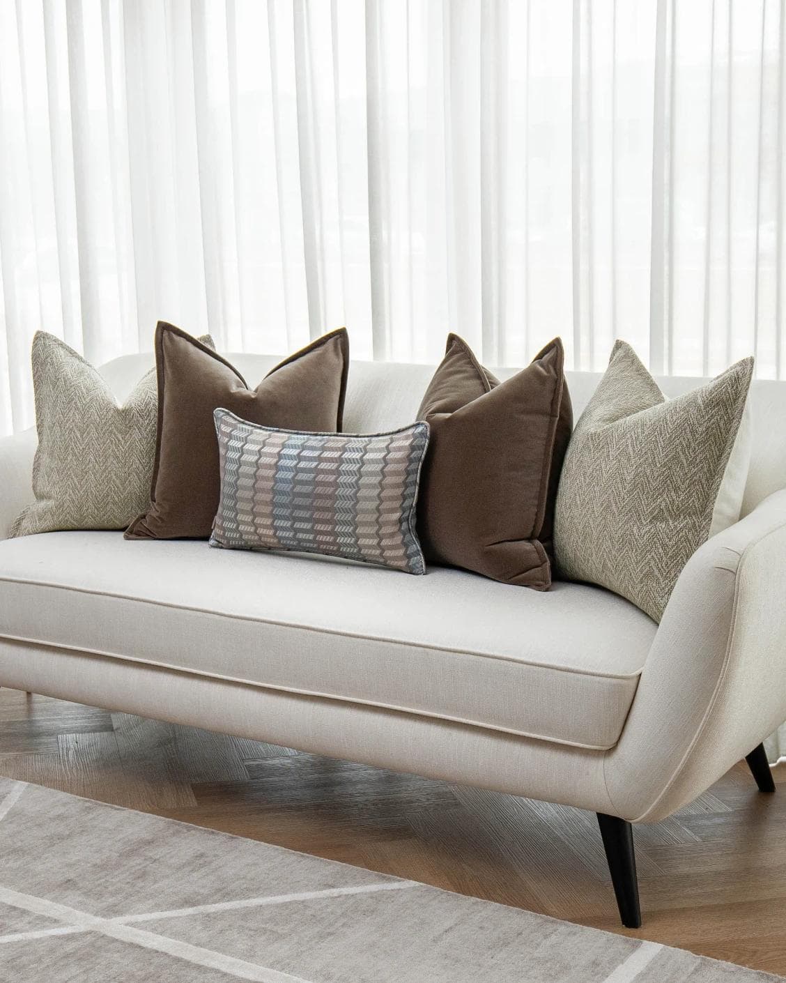 Jovie Bundle cushion in silver, blue, brown and beige, shown in a lifestyle right view as image 2
