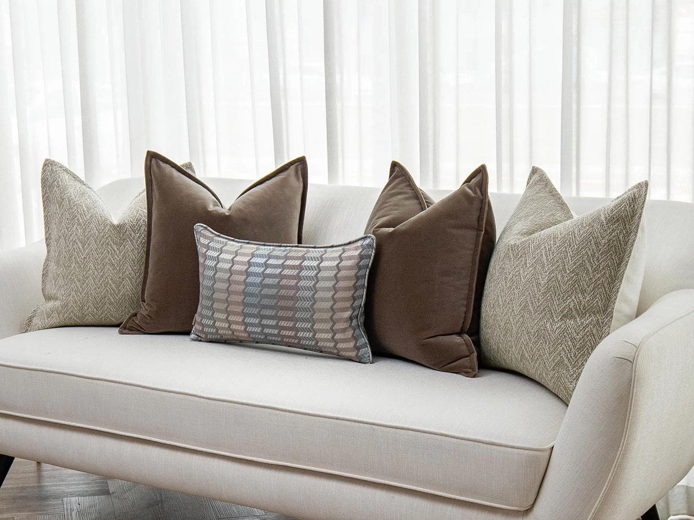 Jovie Bundle cushion in silver, blue, brown and beige, shown in a lifestyle right view as image 2