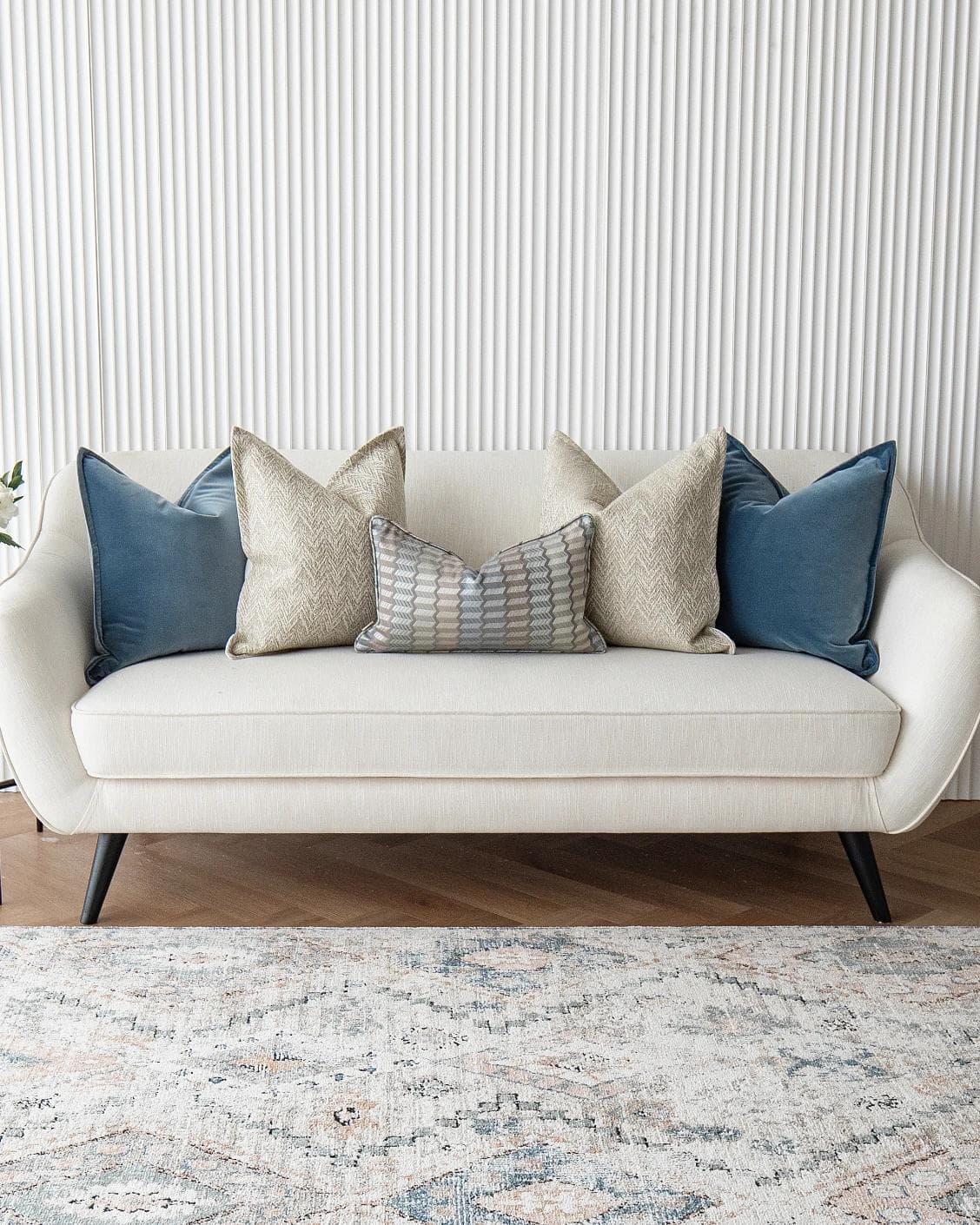 Stephan Bundle cushion in silver, blue and beige, shown in a lifestyle front view as image 2