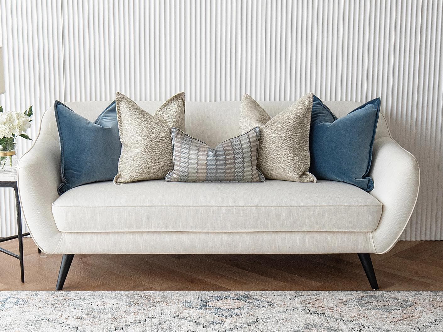Stephan Bundle cushion in silver, blue and beige, shown in a lifestyle front view as image 2