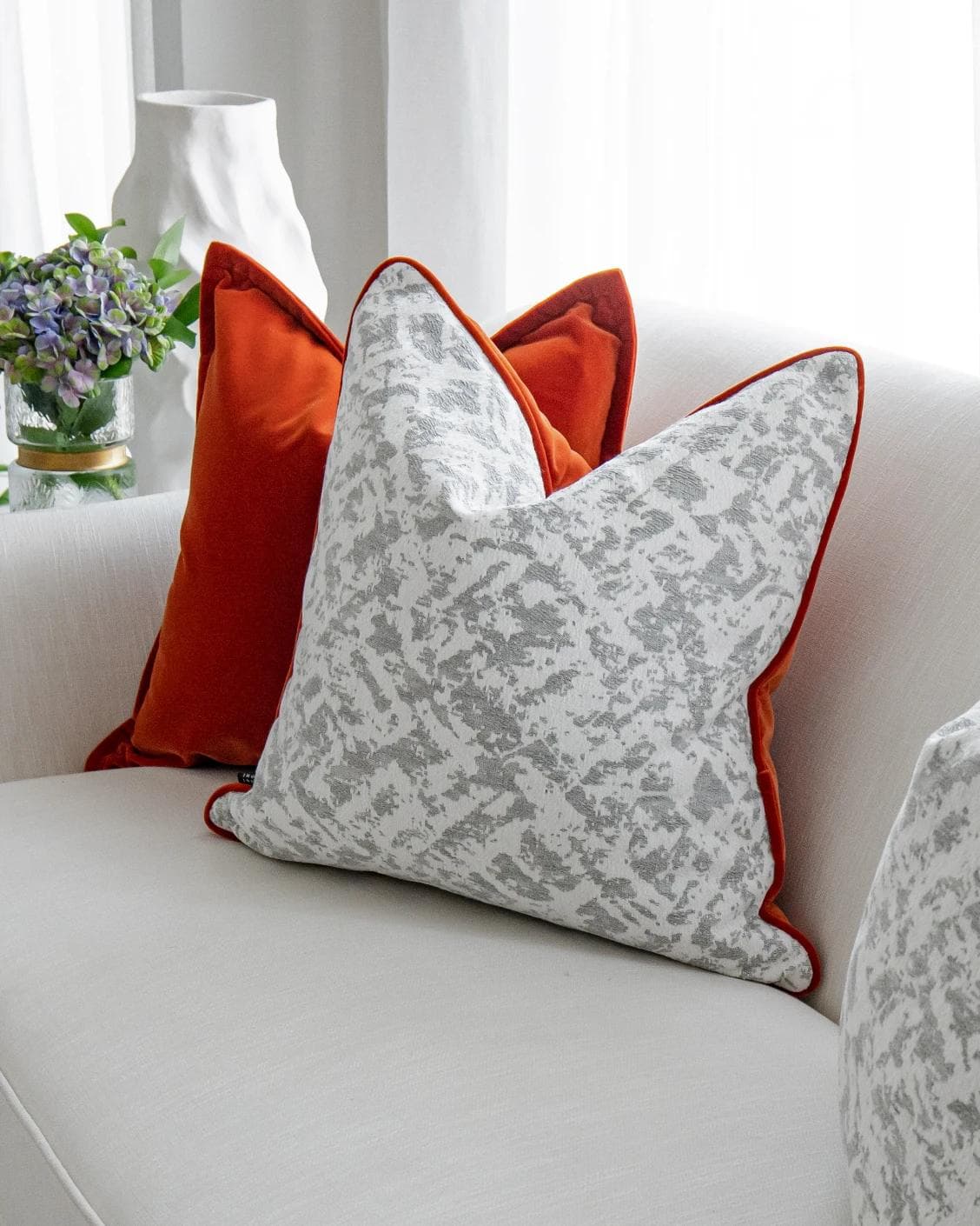 Braddy Bundle cushion in tan, orange, white and silver, shown in a lifestyle right view as image 5