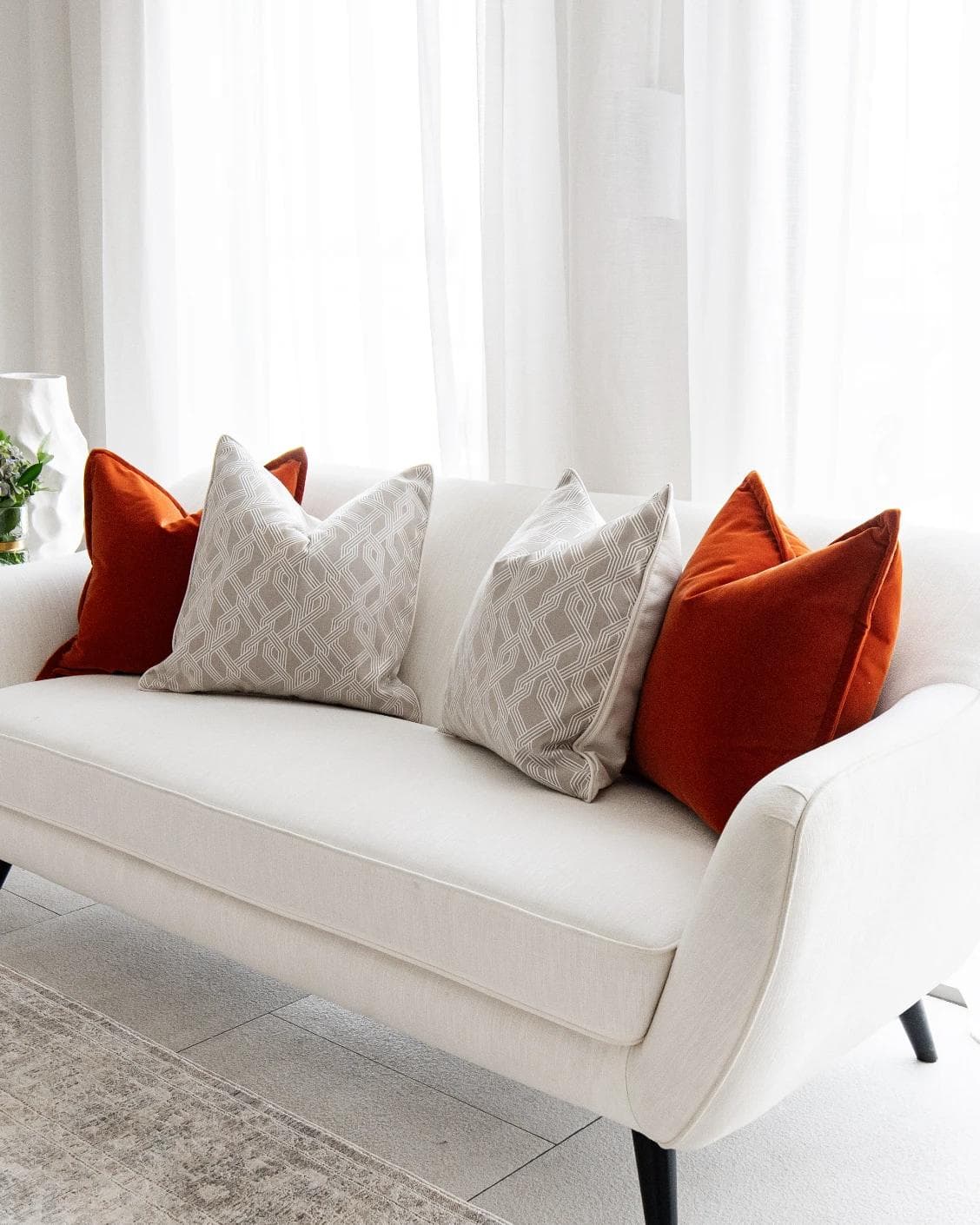Marites Bundle cushion in tan, orange, beige and white, shown in a lifestyle right view as image 2