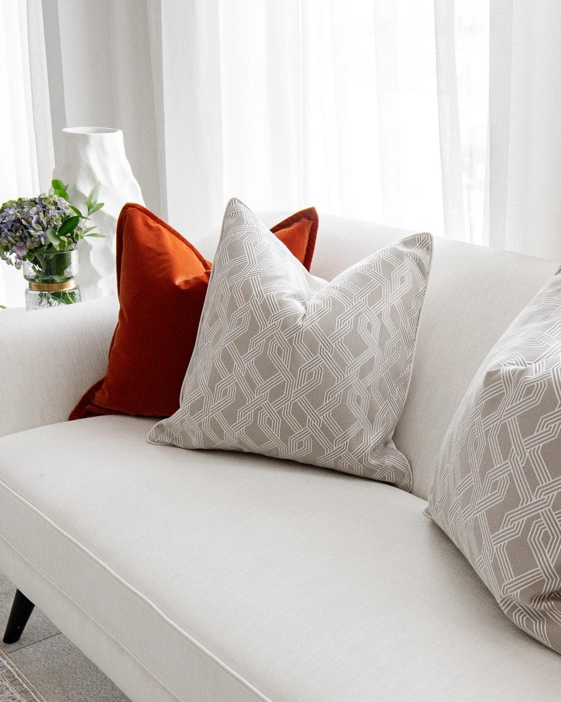 Marites Bundle cushion in tan, orange, beige and white, shown in a lifestyle right view as image 5