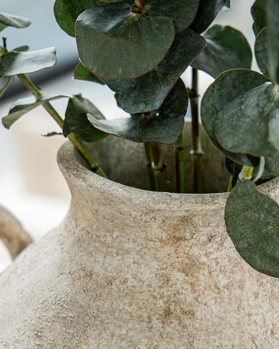 Vess Terra vases in stone and grey, shown in a lifestyle close-up as image 5