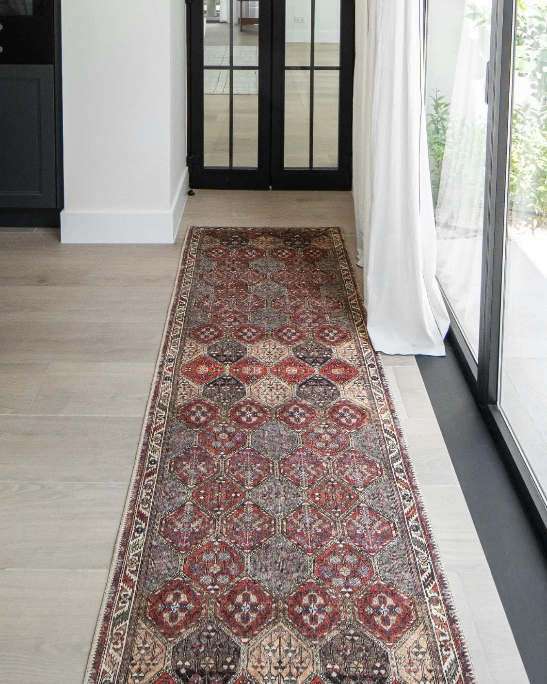 Vince Rosso Runners carpet in rust and multicolour, shown in a lifestyle front view