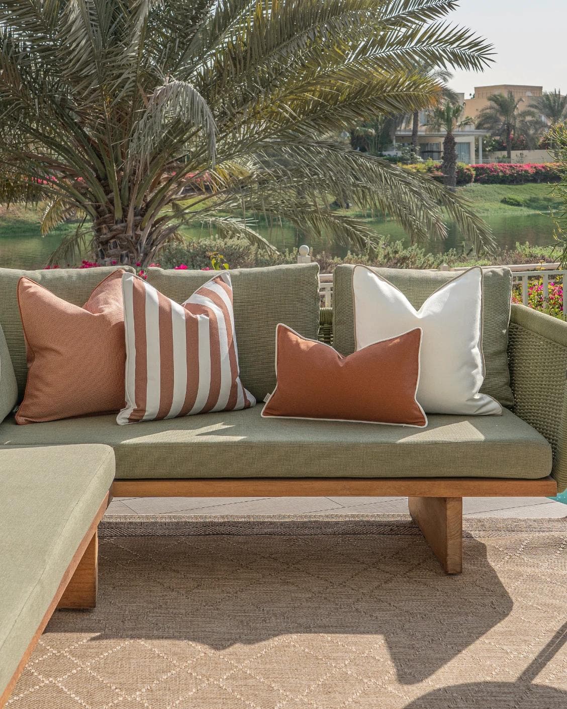 Vion Bundle cushion in rust and ivory, shown in a lifestyle front view as image 4