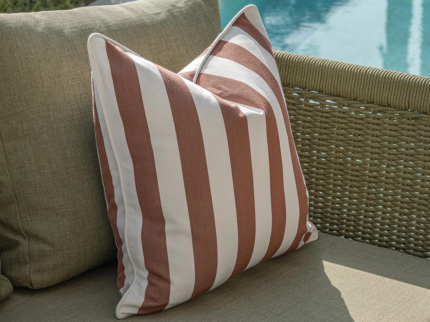Vion Bundle cushion in rust and ivory, shown in a lifestyle left view as image 5