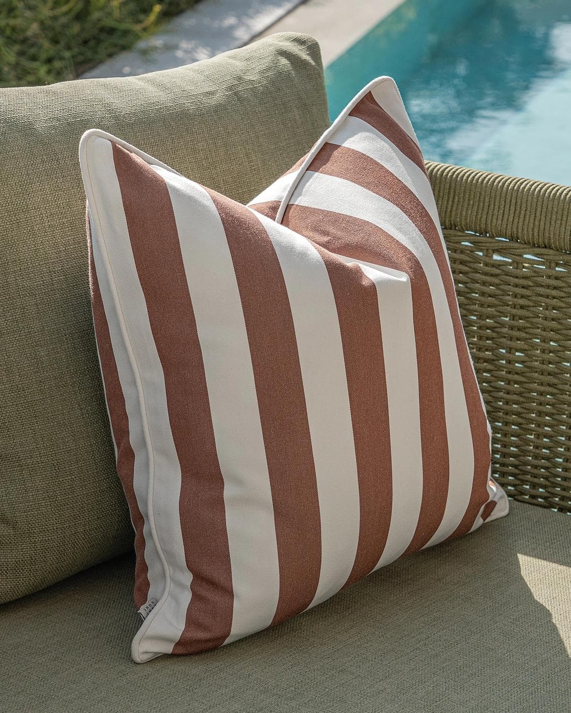Vion Bundle cushion in rust and ivory, shown in a lifestyle left view as image 5
