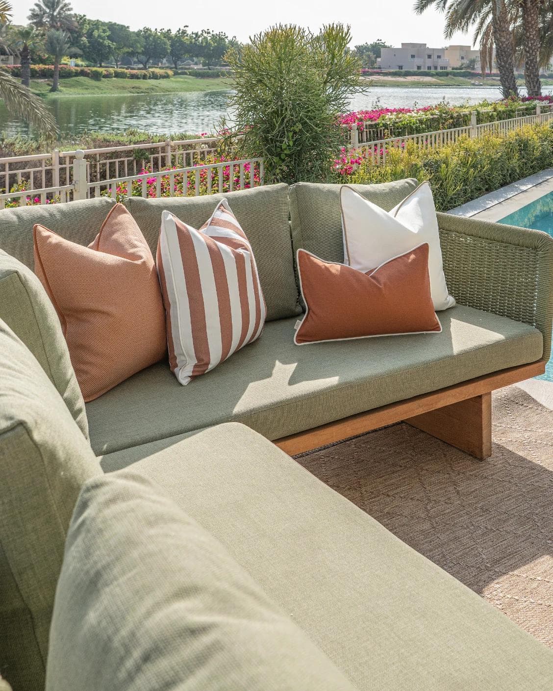 Vion Bundle cushion in rust and ivory, shown in a lifestyle left view as image 2