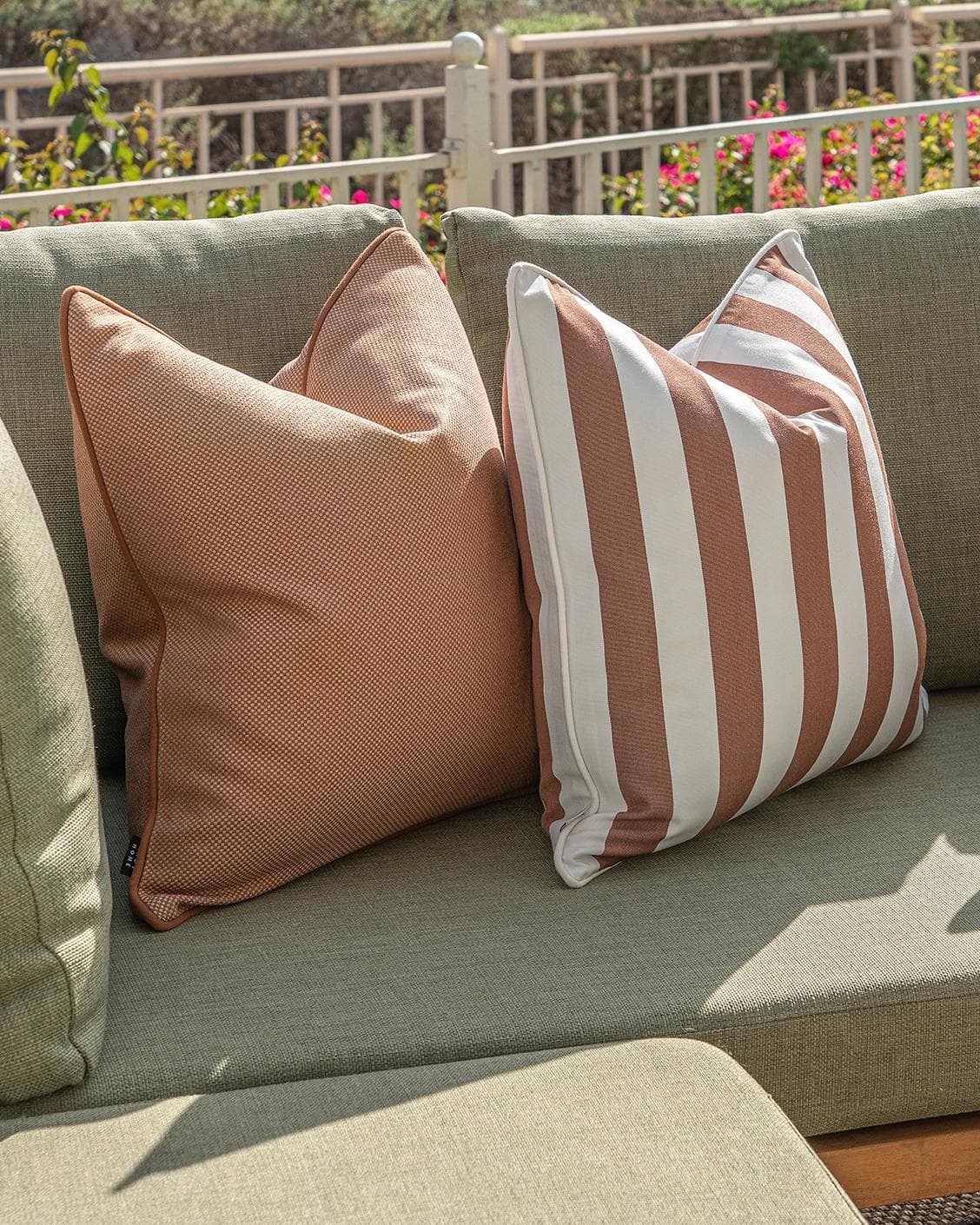 Vion Bundle cushion in rust and ivory, shown in a lifestyle left view as image 6