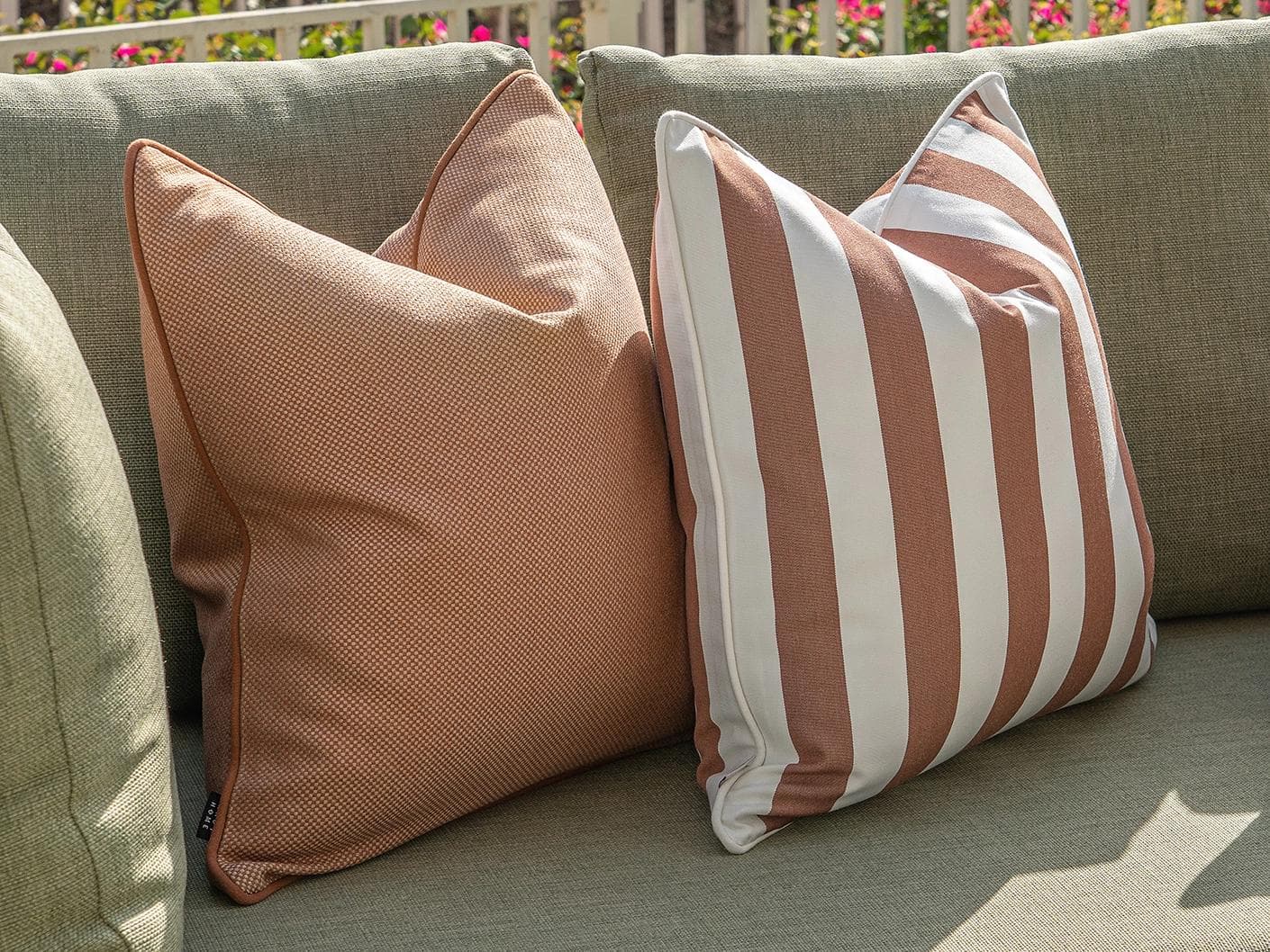 Vion Bundle cushion in rust and ivory, shown in a lifestyle left view as image 6