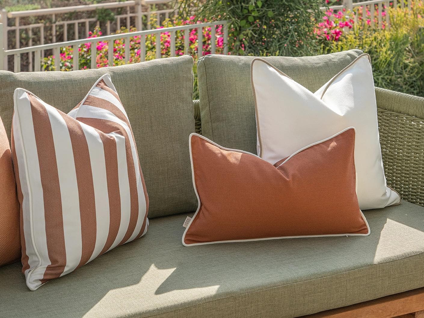 Vion Bundle cushion in rust and ivory, shown in a lifestyle left view as image 7