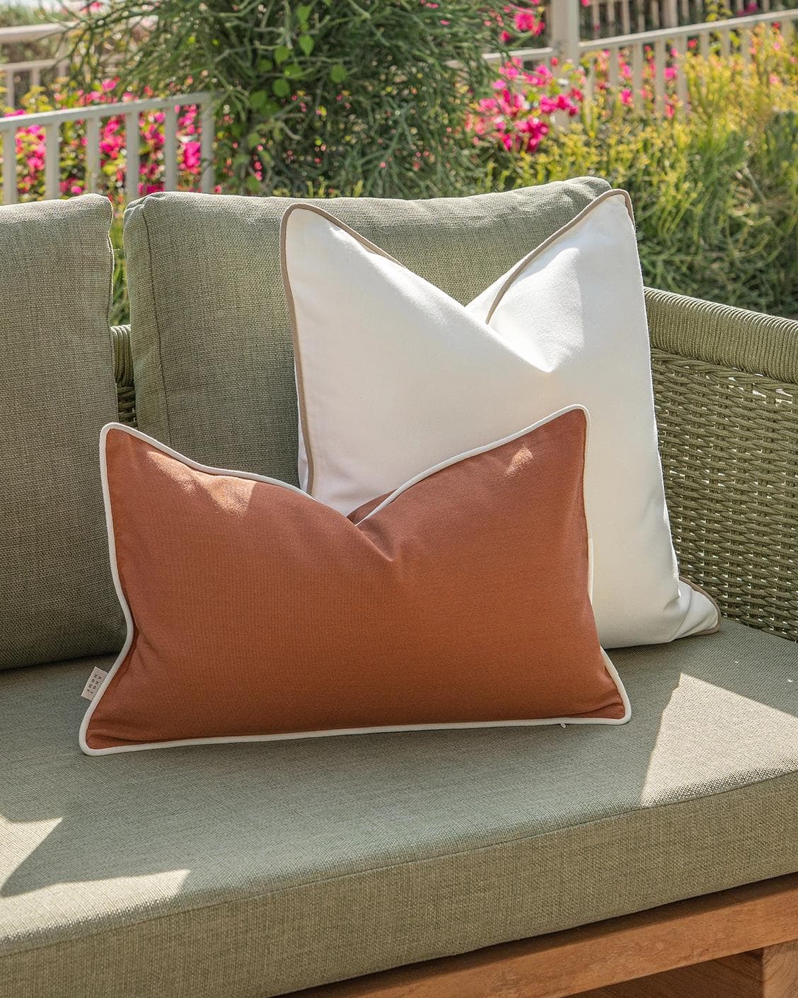 Vion Bundle cushion in rust and ivory, shown in a lifestyle left view as image 7