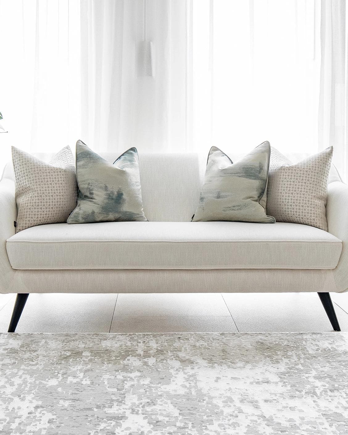 Orlan Bundle cushion in blue, silver and white, shown in a lifestyle front view as image 4
