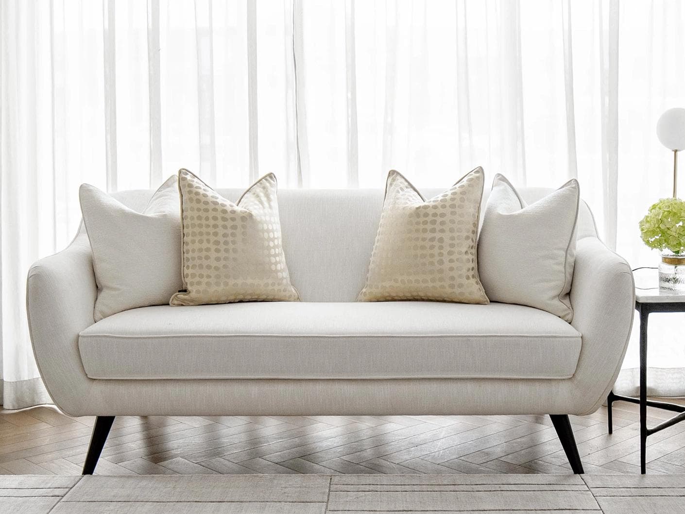 Sovanna Bundle cushion in white, beige and gold, shown in a lifestyle front view as image 4