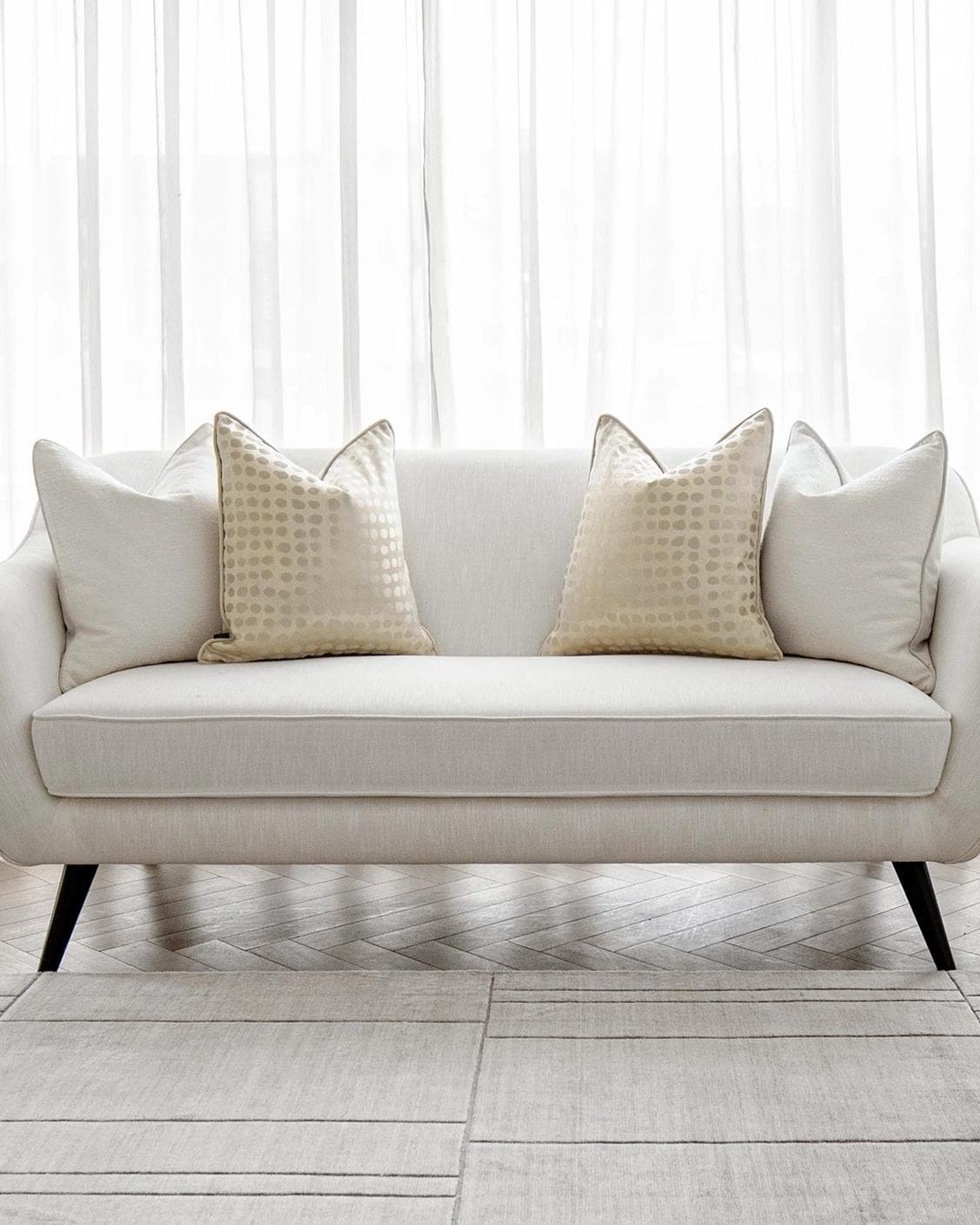 Sovanna Bundle cushion in white, beige and gold, shown in a lifestyle front view as image 4
