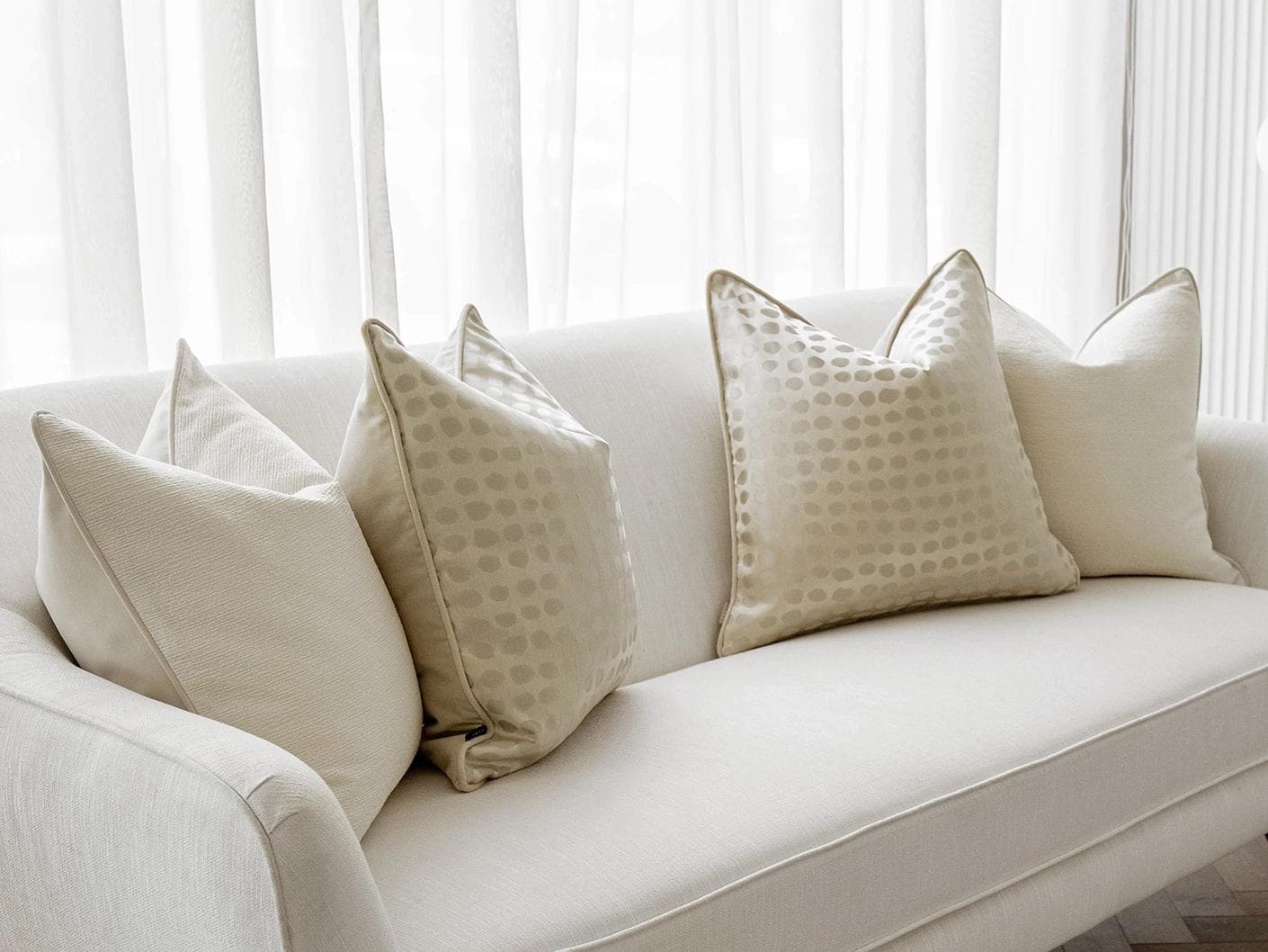 Sovanna Bundle cushion in white, beige and gold, shown in a lifestyle left view as image 2