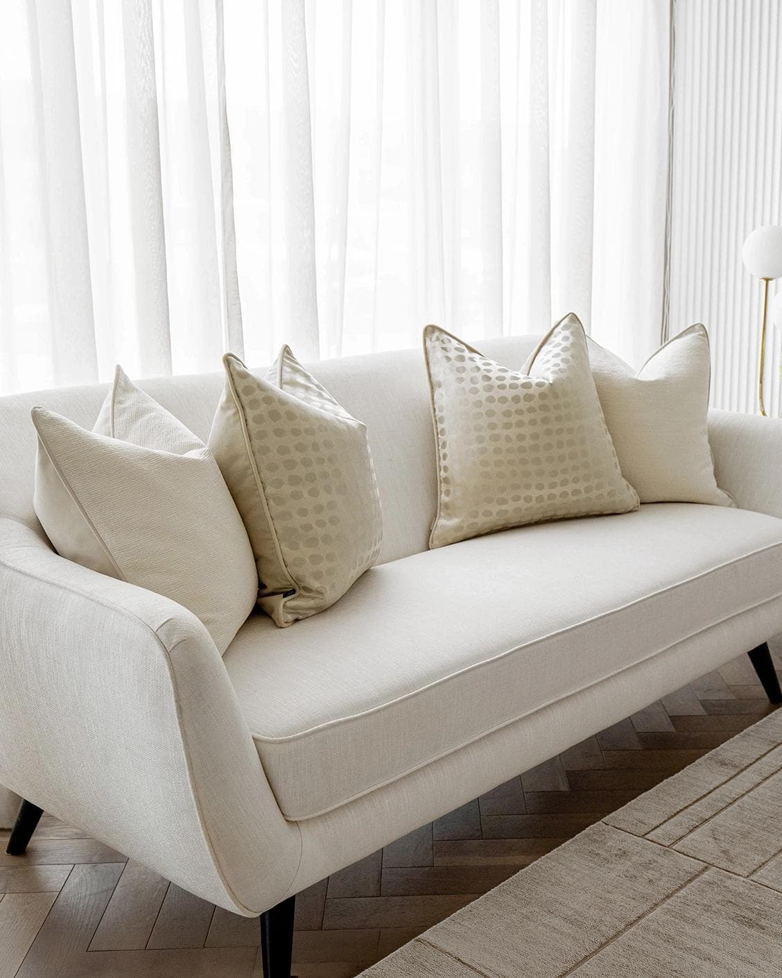 Sovanna Bundle cushion in white, beige and gold, shown in a lifestyle left view as image 2