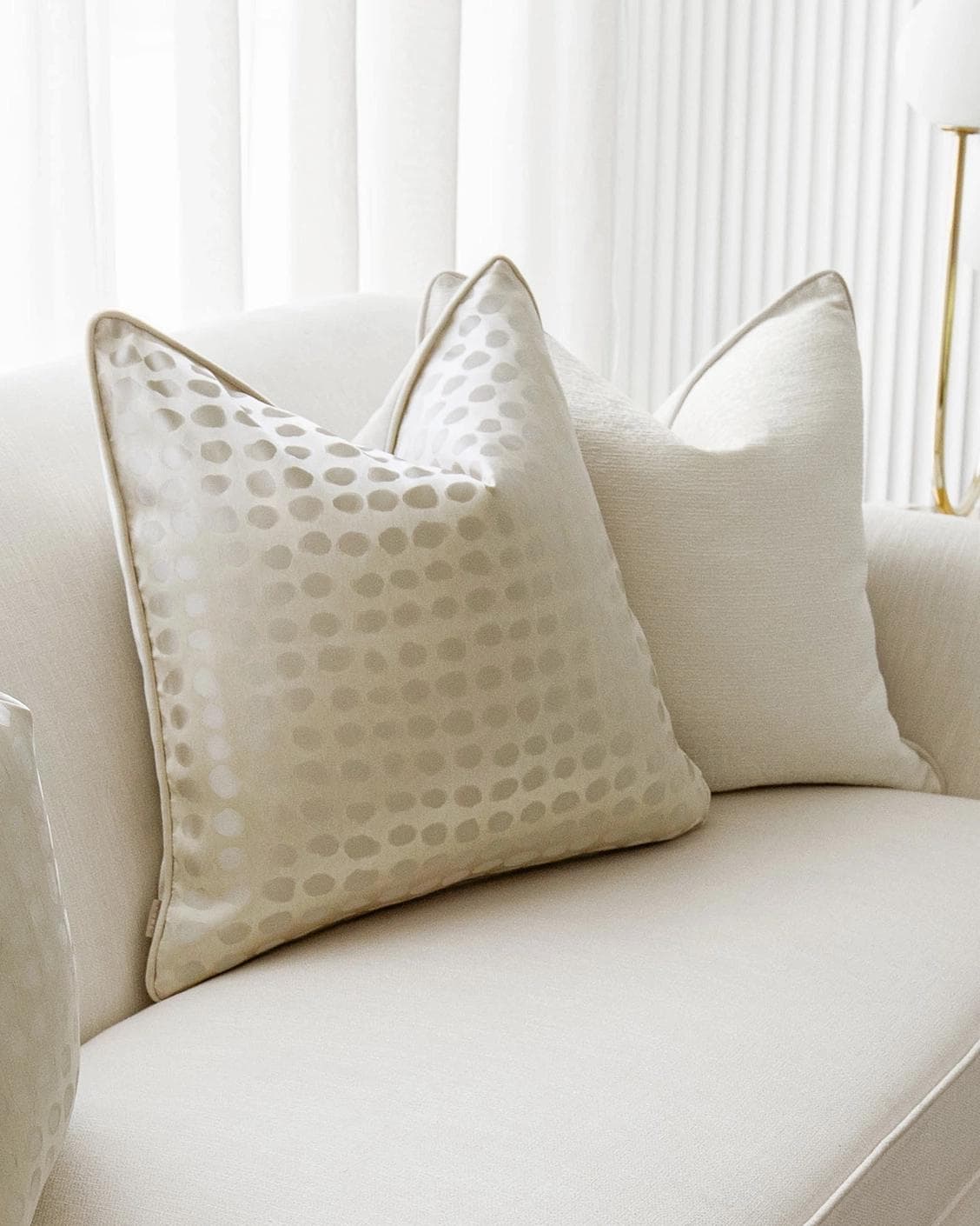 Sovanna Bundle cushion in white, beige and gold, shown in a lifestyle left view as image 5