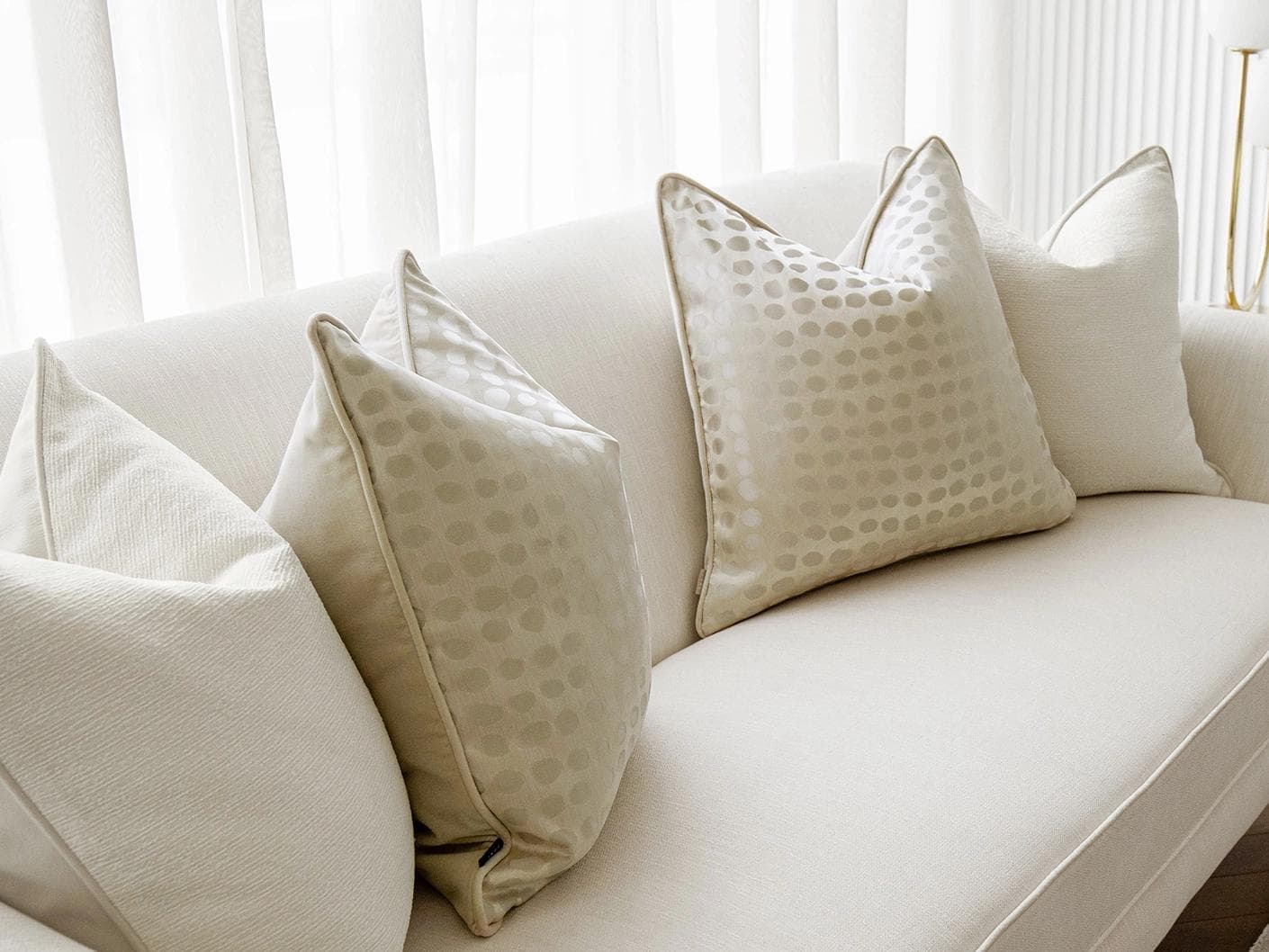 Sovanna Bundle cushion in white, beige and gold, shown in a lifestyle left view as image 5