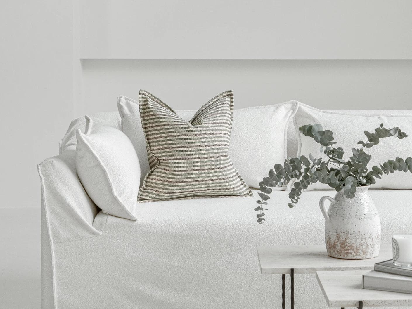 Wren Pistachio cushion in green and ivory, shown in a lifestyle front view as image 4