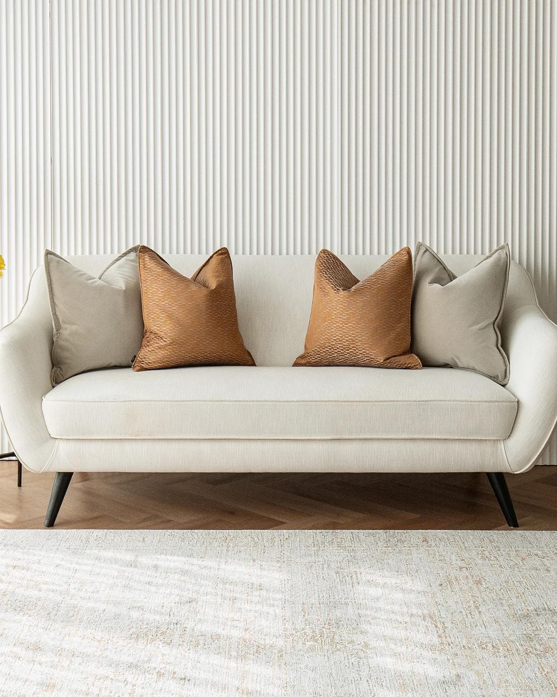 Yabella Bundle cushion in grey and orange, shown in a lifestyle front view as image 4
