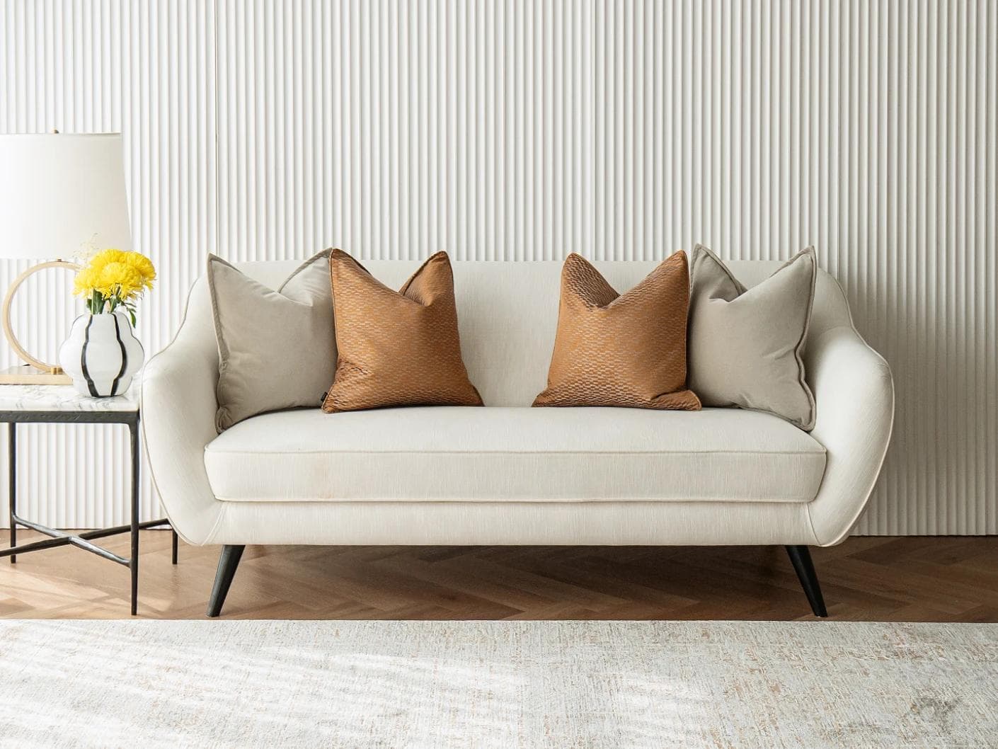 Yabella Bundle cushion in grey and orange, shown in a lifestyle front view as image 4