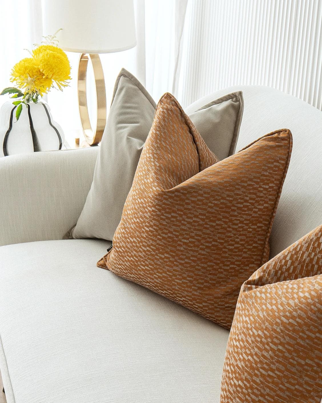 Yabella Bundle cushion in grey and orange, shown in a lifestyle right view as image 5
