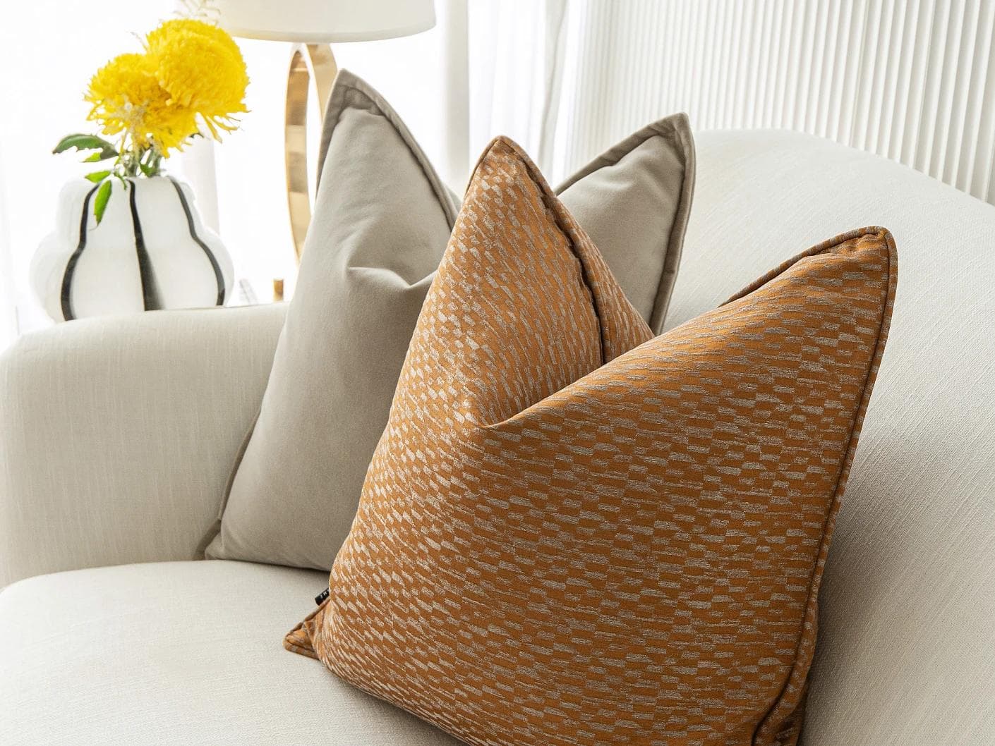 Yabella Bundle cushion in grey and orange, shown in a lifestyle right view as image 6