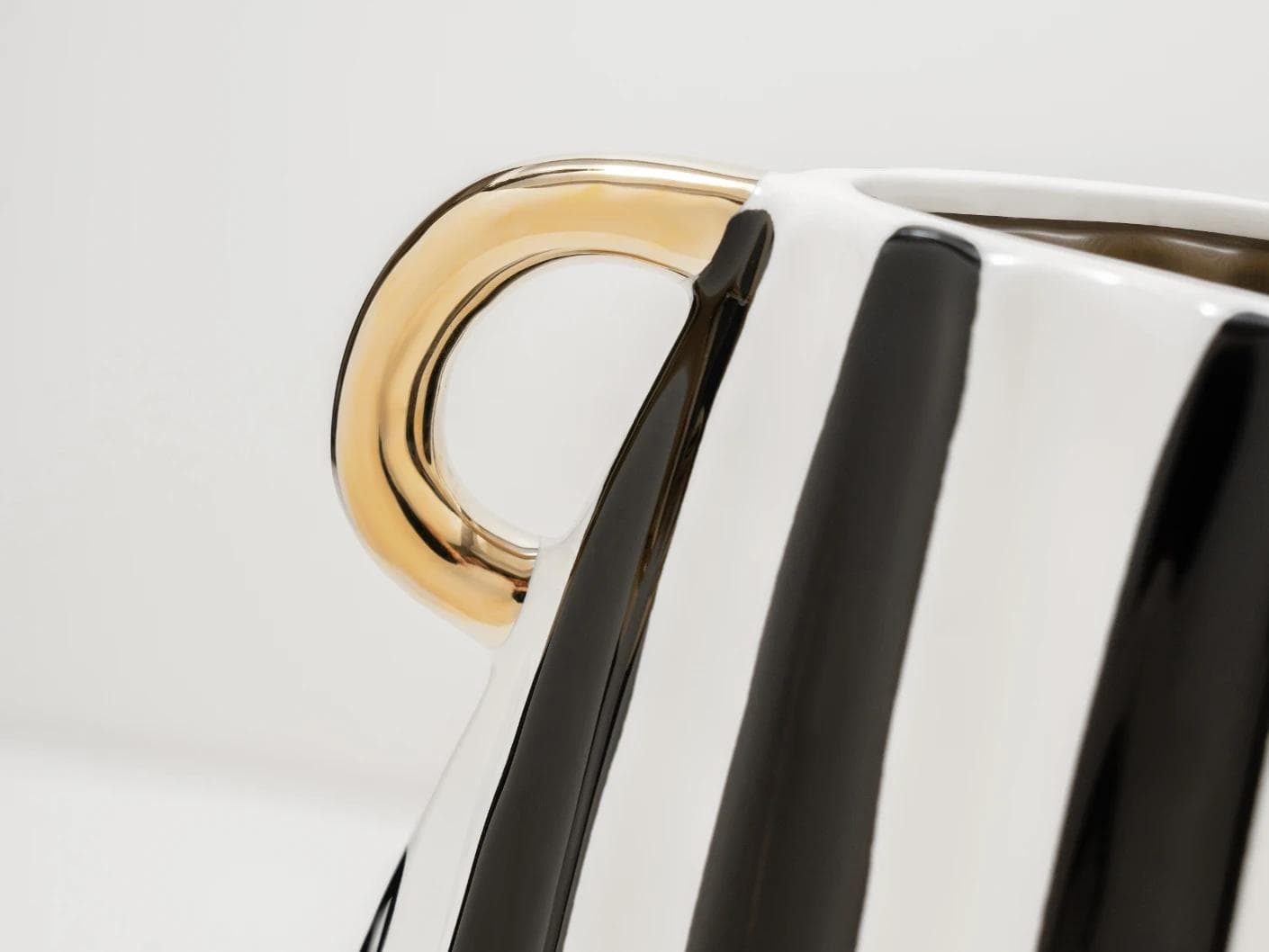 Yara Arneson vases in gold, black and white, shown in a product close-up as image 7